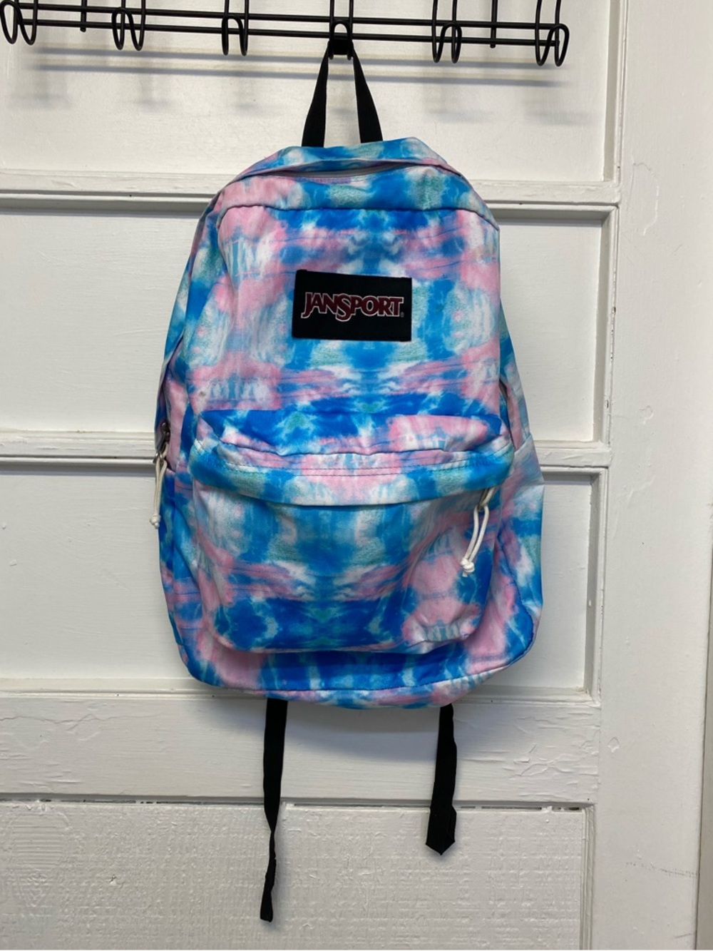 JanSport SuperBreak backpack school bag in a pink and blue tie-dye pattern.